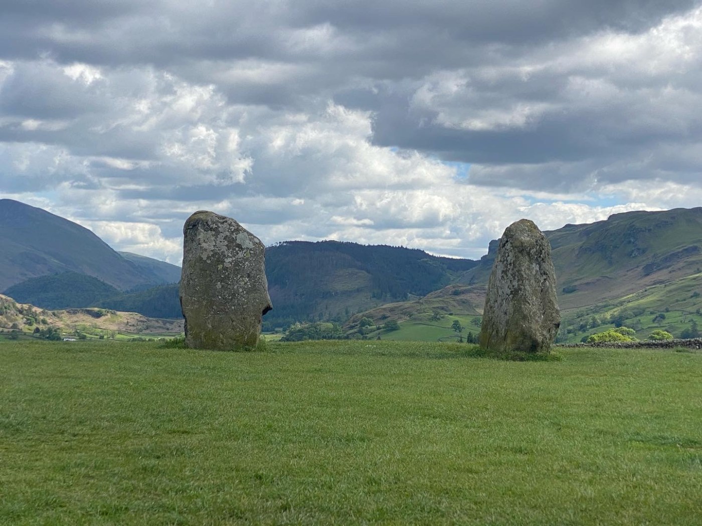 standing stones above a valley with mountains
