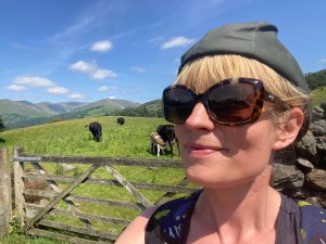 Lady wearing sunglasses, rural background