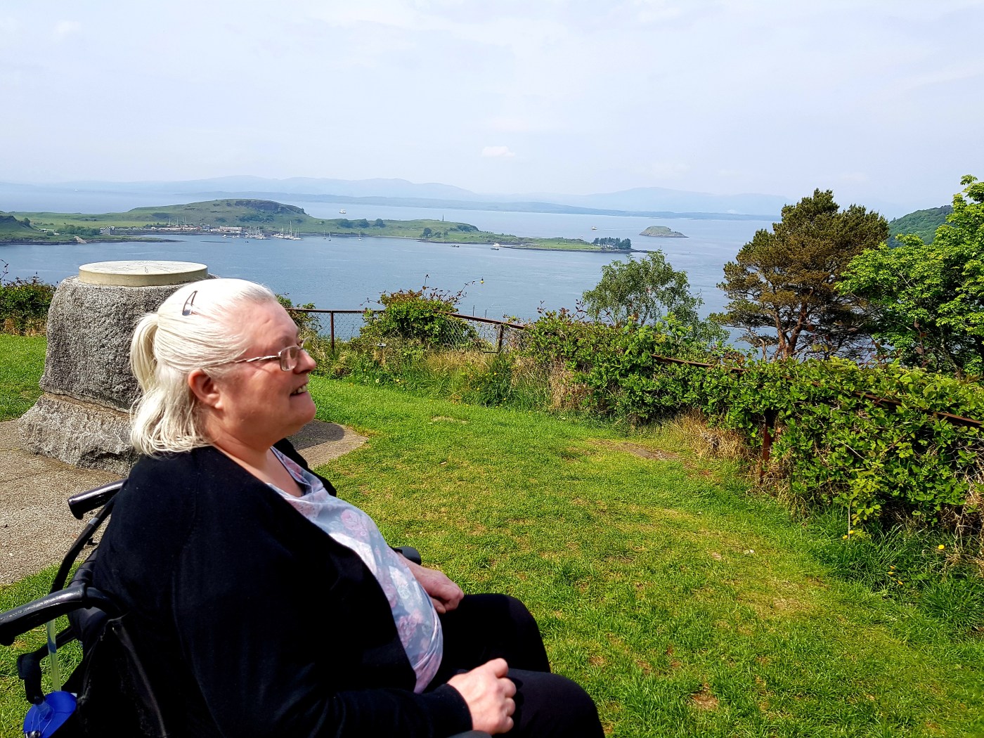 Woman in wheelchair looking out to sea