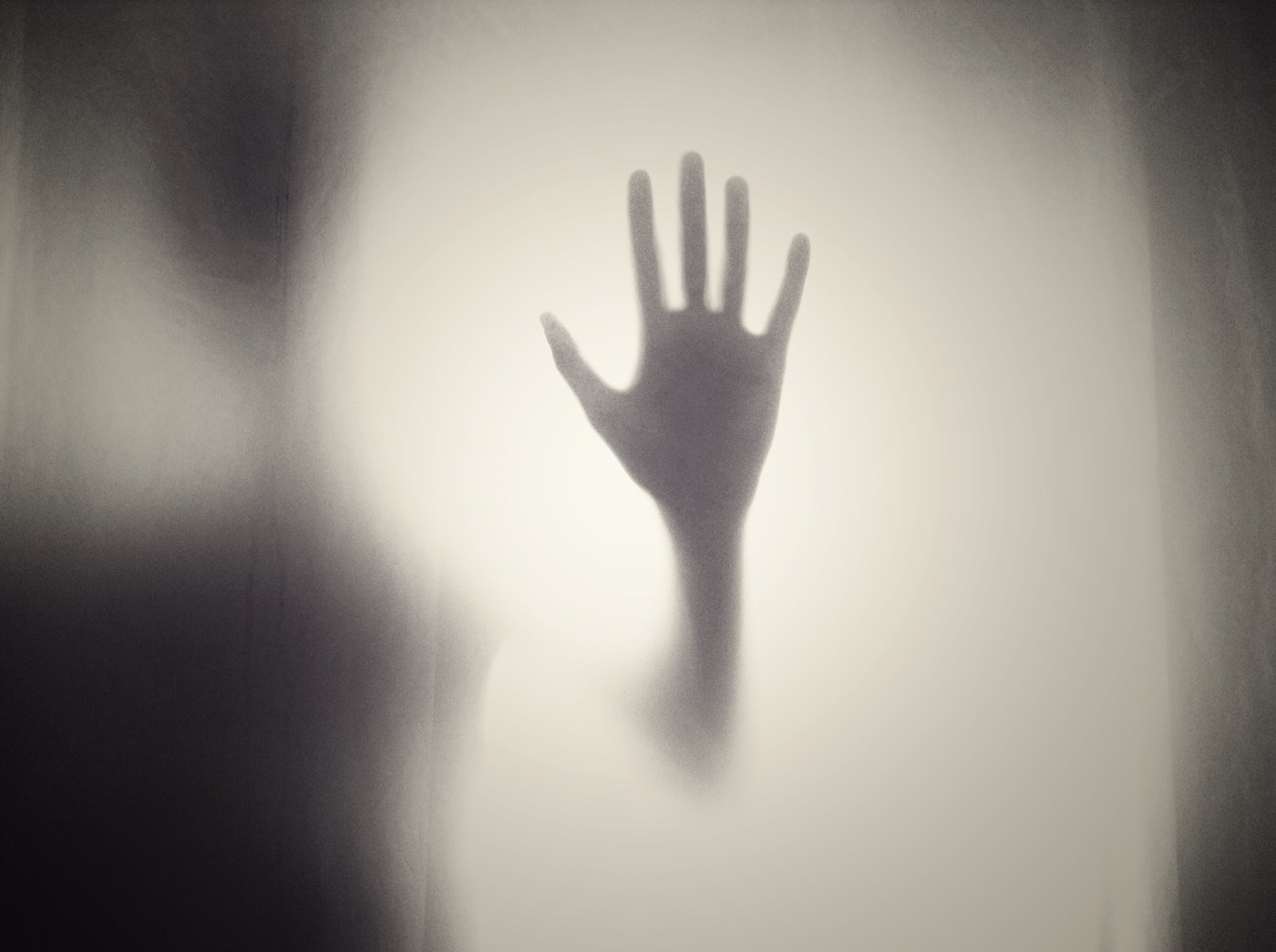 ghostly figure with upraised hand