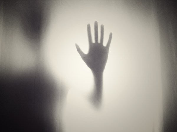 ghostly figure with upraised hand