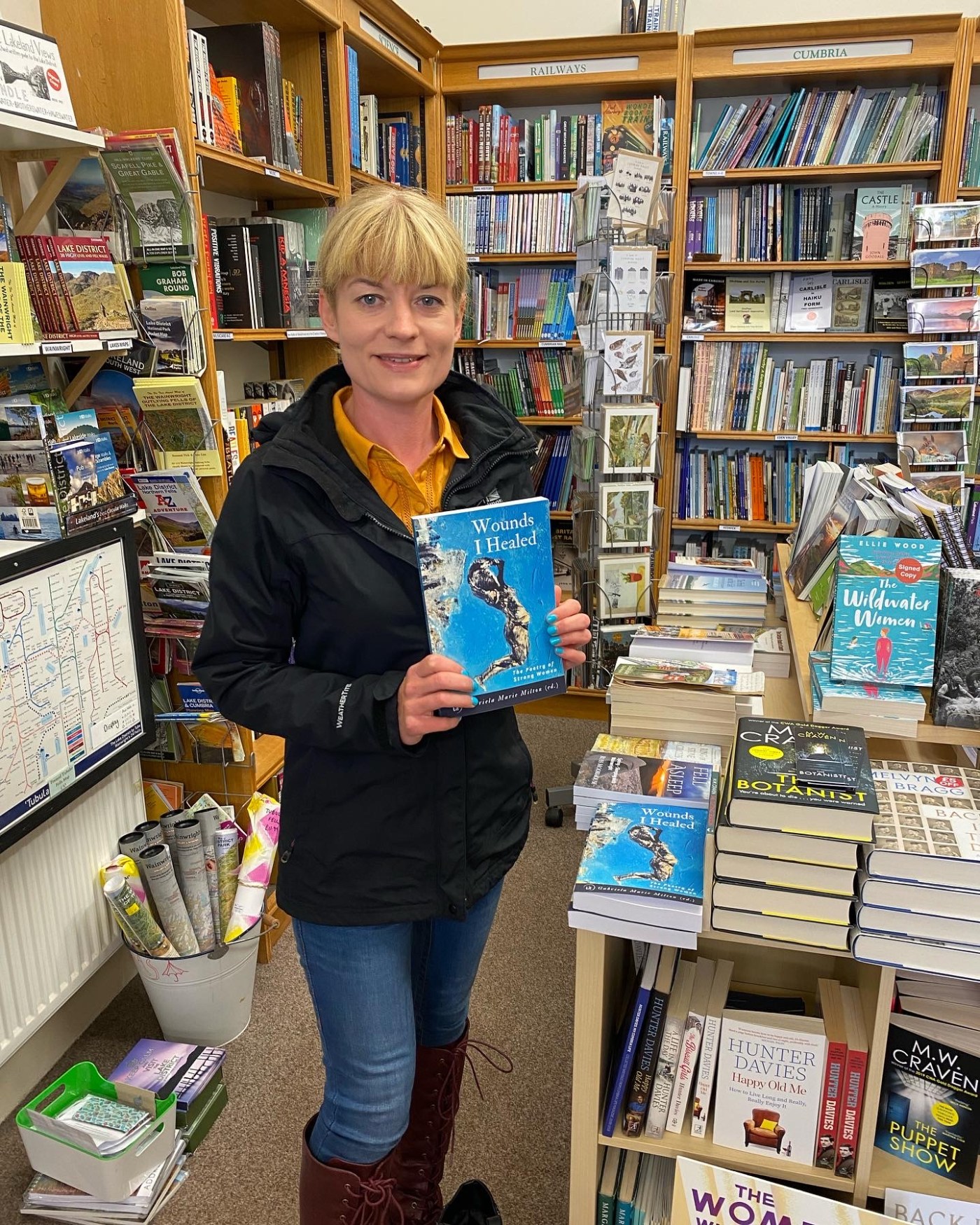 Woman holding a book in a bookstore